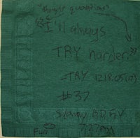 a green napkin with writing on it