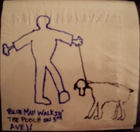 a napkin with a drawing of a man and a dog